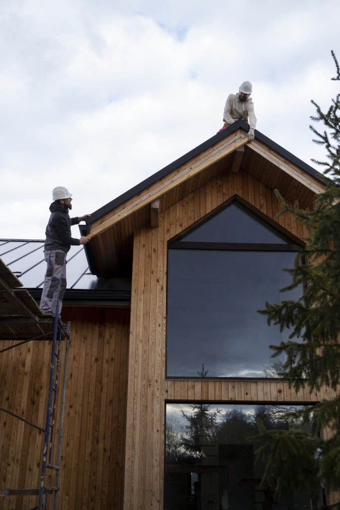 Two workers installing wooden house roof. | The Bearded Contractor