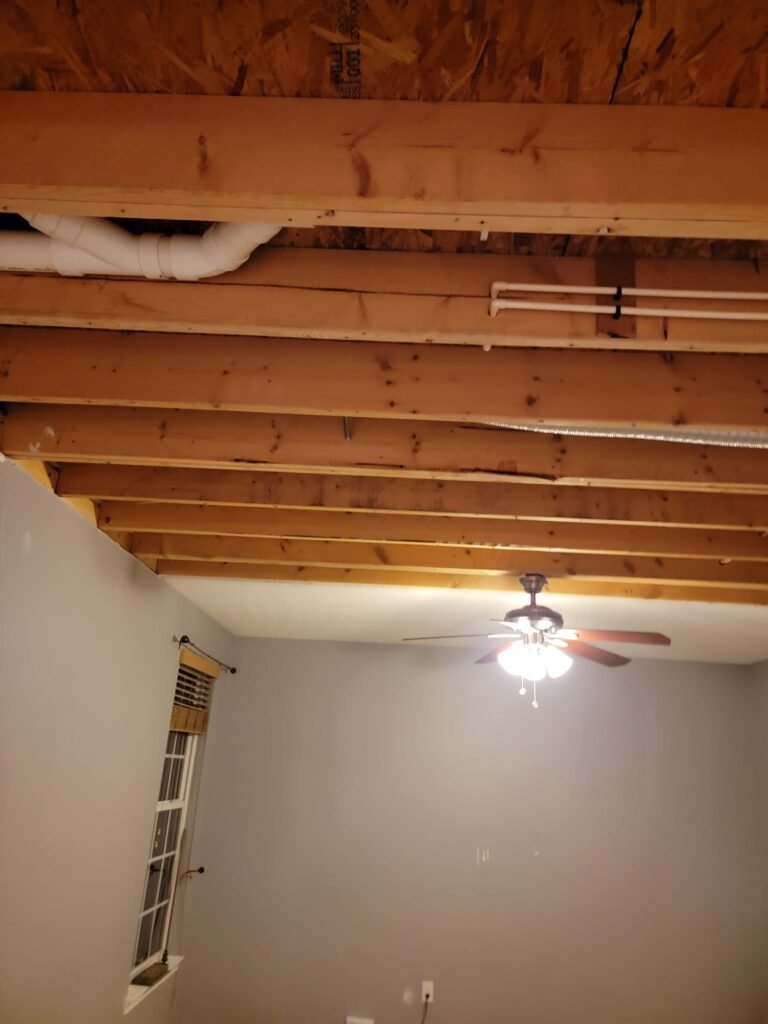 Exposed wooden joist ceiling room. | The Bearded Contractor